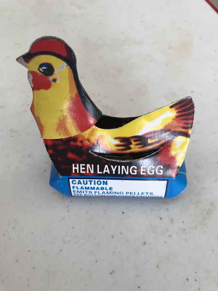 Hen laying egg single item